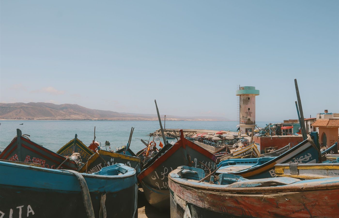 Vibrant fishing boats along the picturesque coast of Imsouane, Morocco.