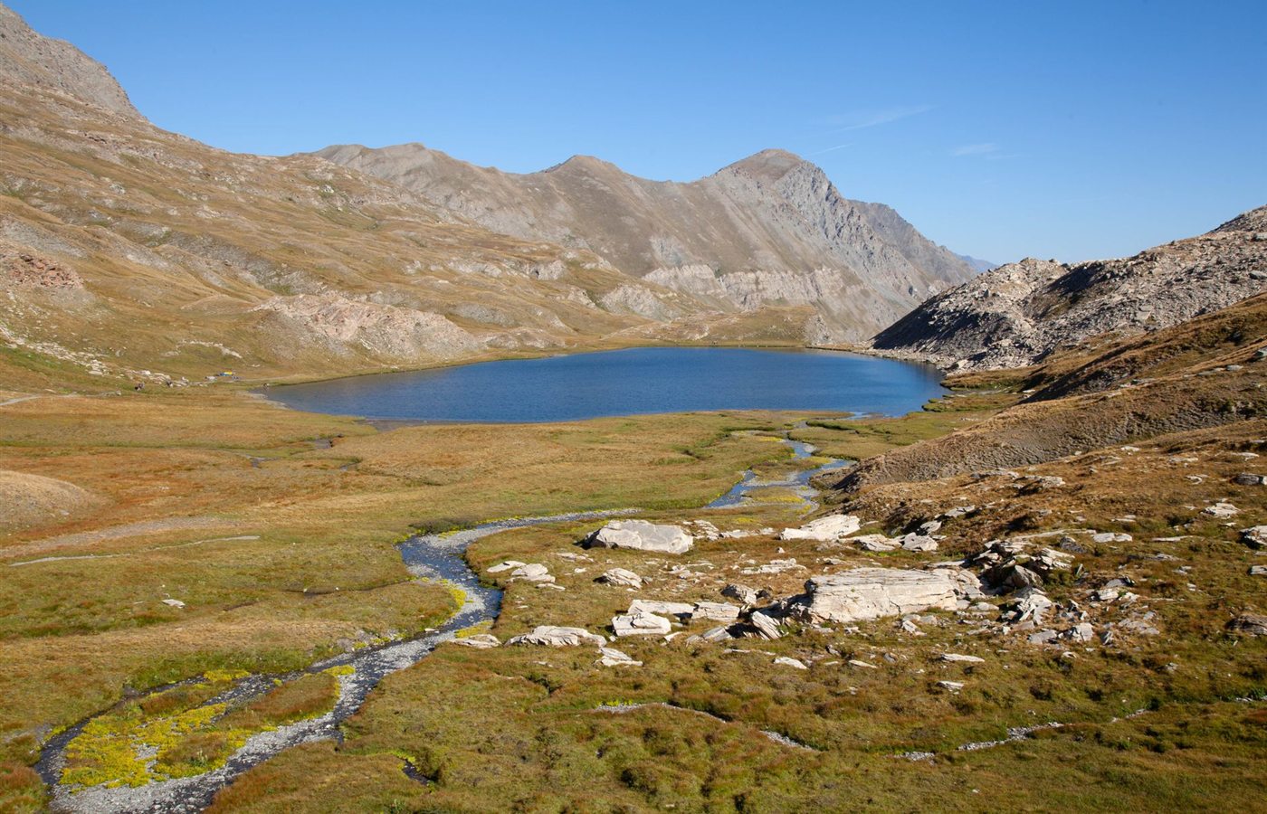 Scenic landscape of Lac Mézan in the French Alps, showcasing its serene beauty.